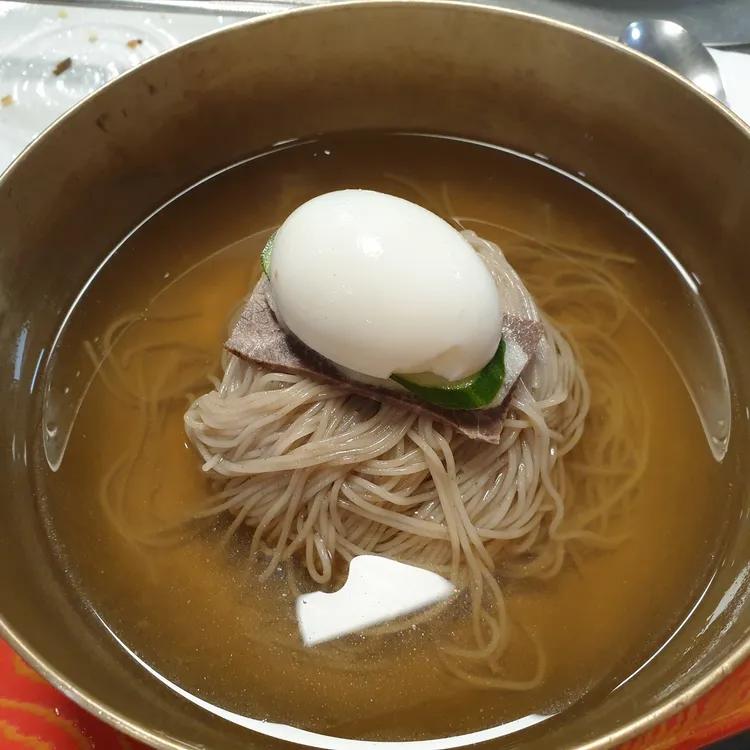 강서면옥 평양냉면의 맑은 육수와 가는 면, 고기와 오이, 달걀 고명